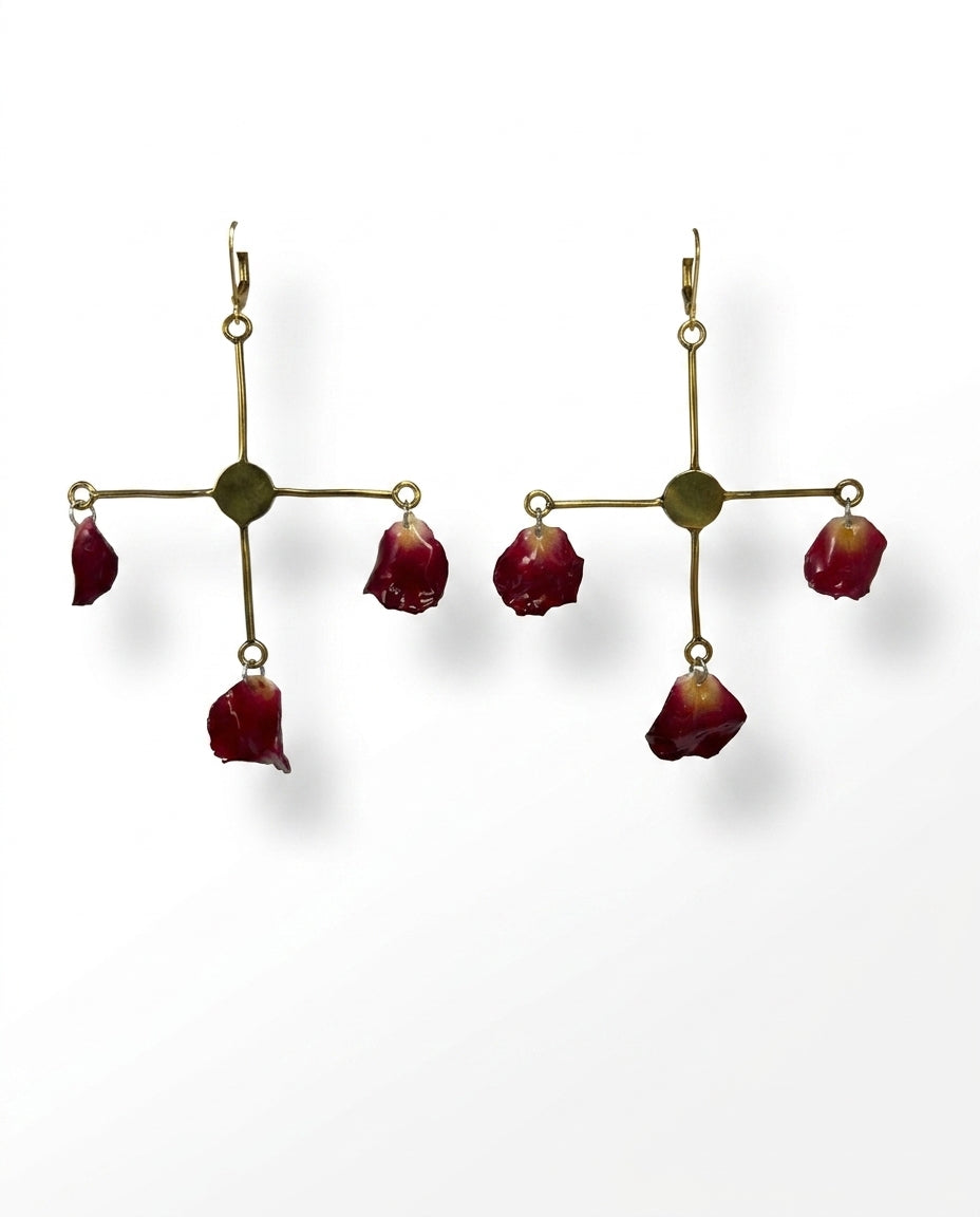 cross red rose petal on brass chandelier