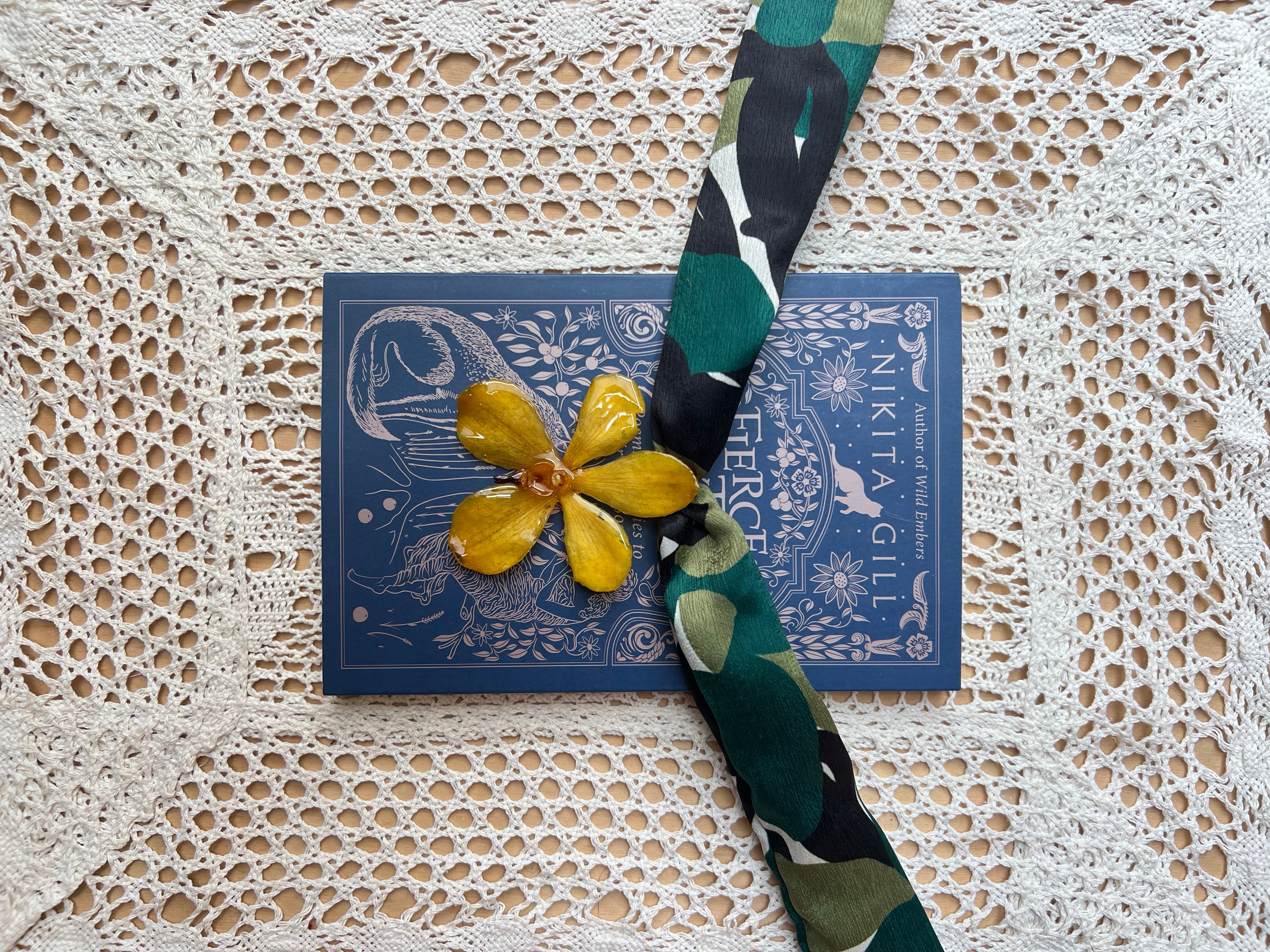 Yellow orchid on green scarf