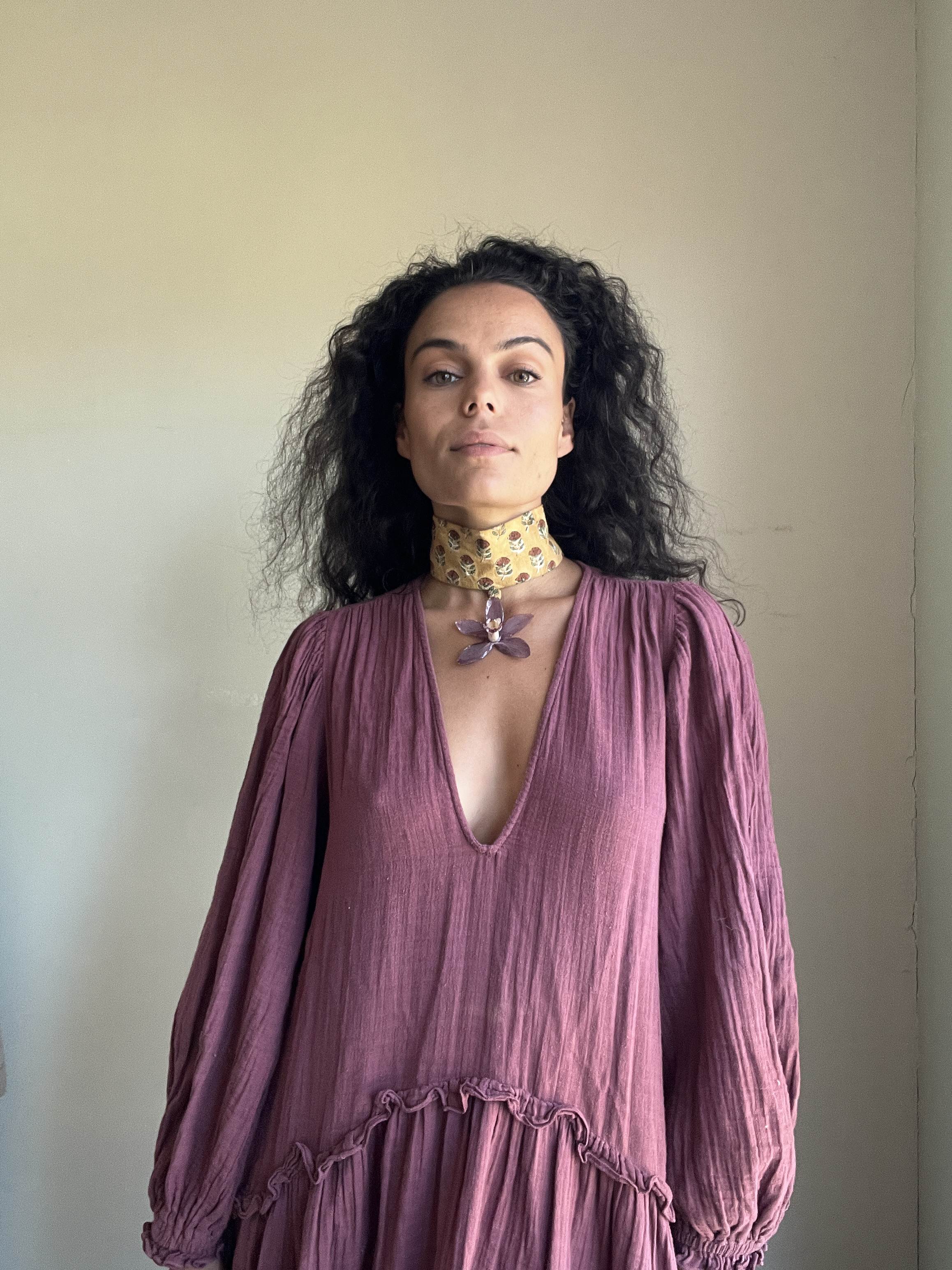 Purple orchid on mustard choker.