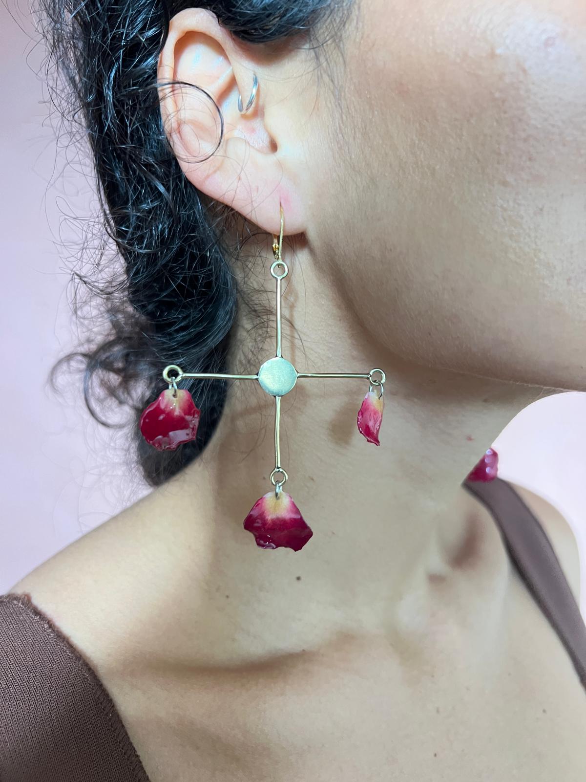 cross red rose petal on brass chandelier