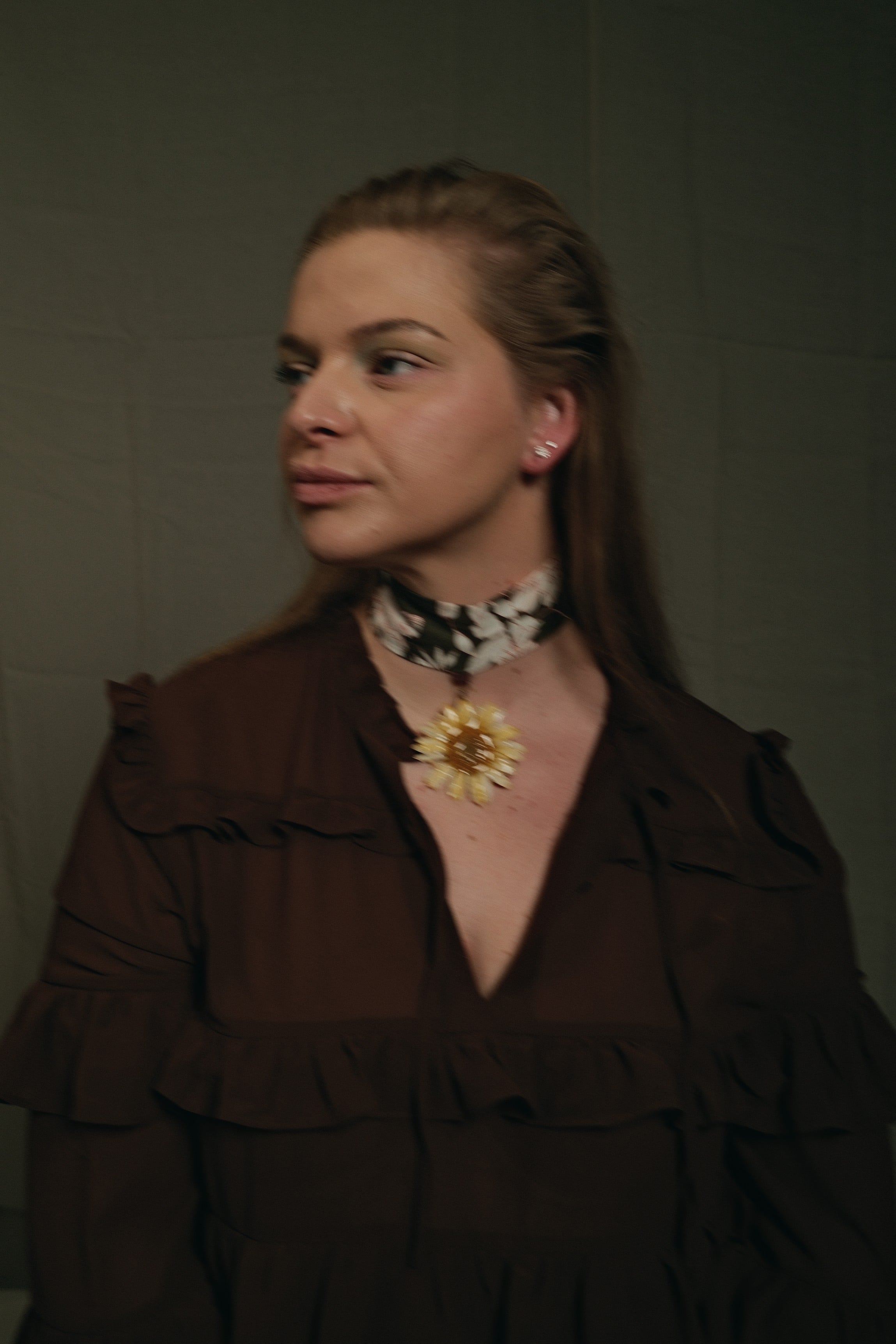 yellow gerbara flower on a green floral choker