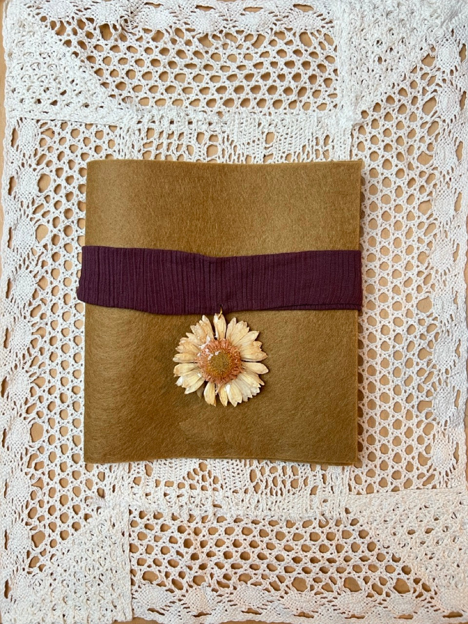 midsize gerbara on bordeaux cotton choker.