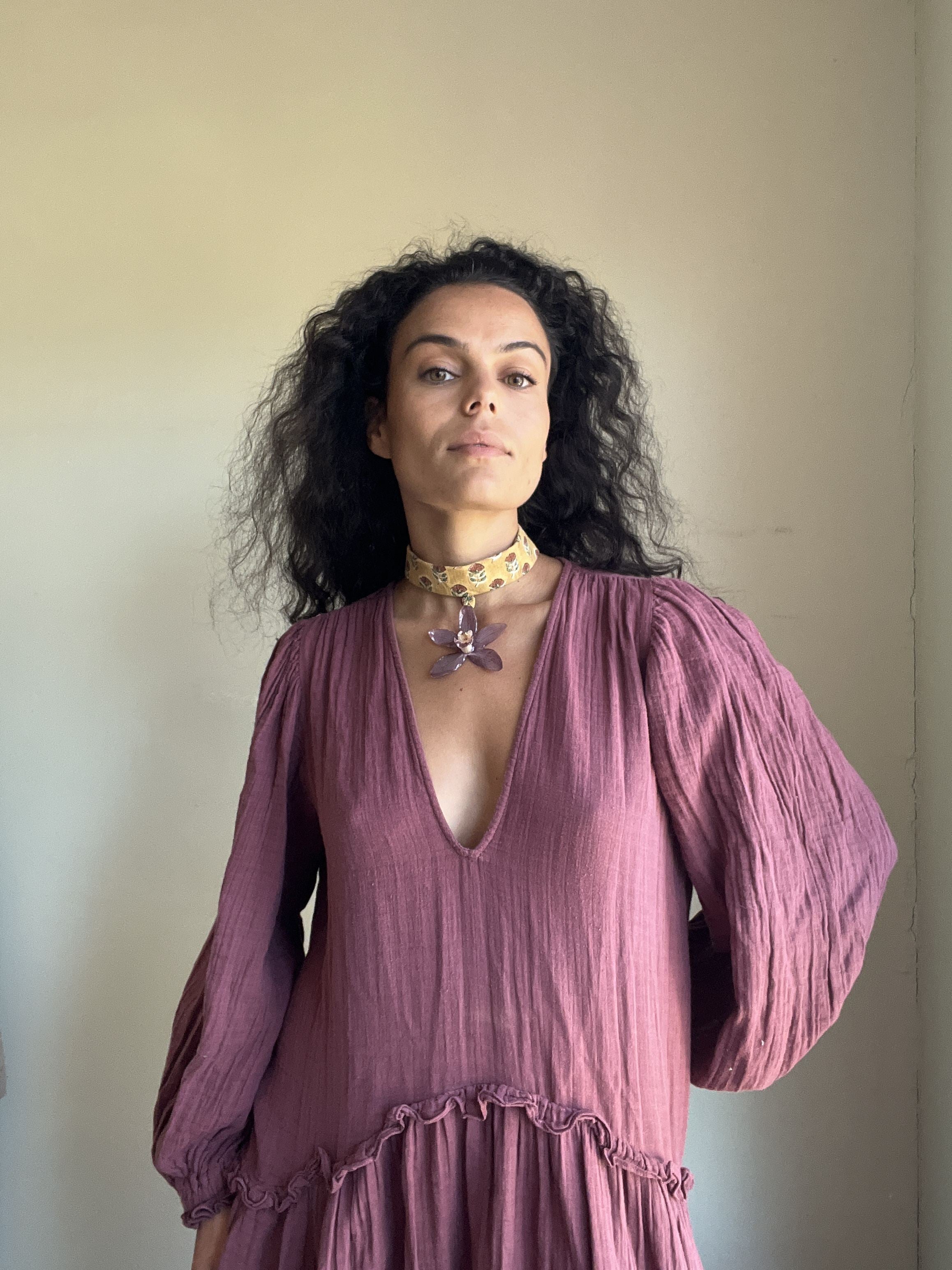 Purple orchid on mustard choker.