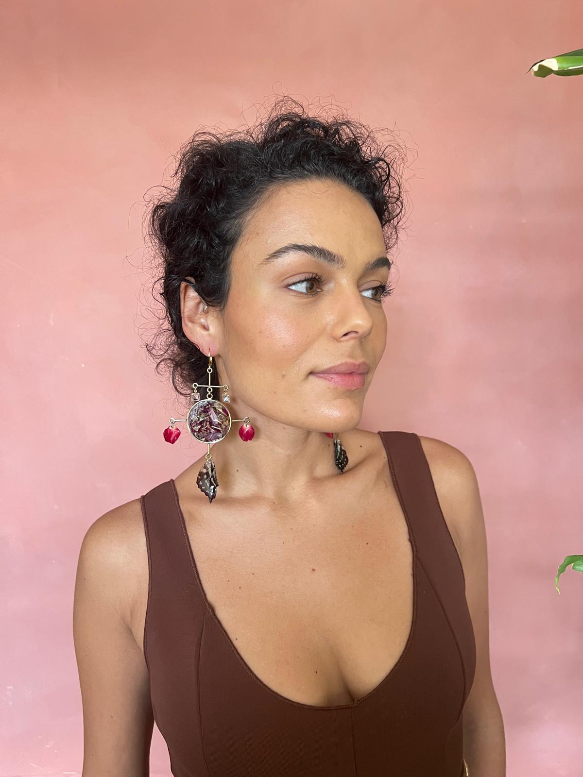 Rose Chandelier featuring butterfly wing, rose petals, loose leaves in round frame and two glass diamonds.