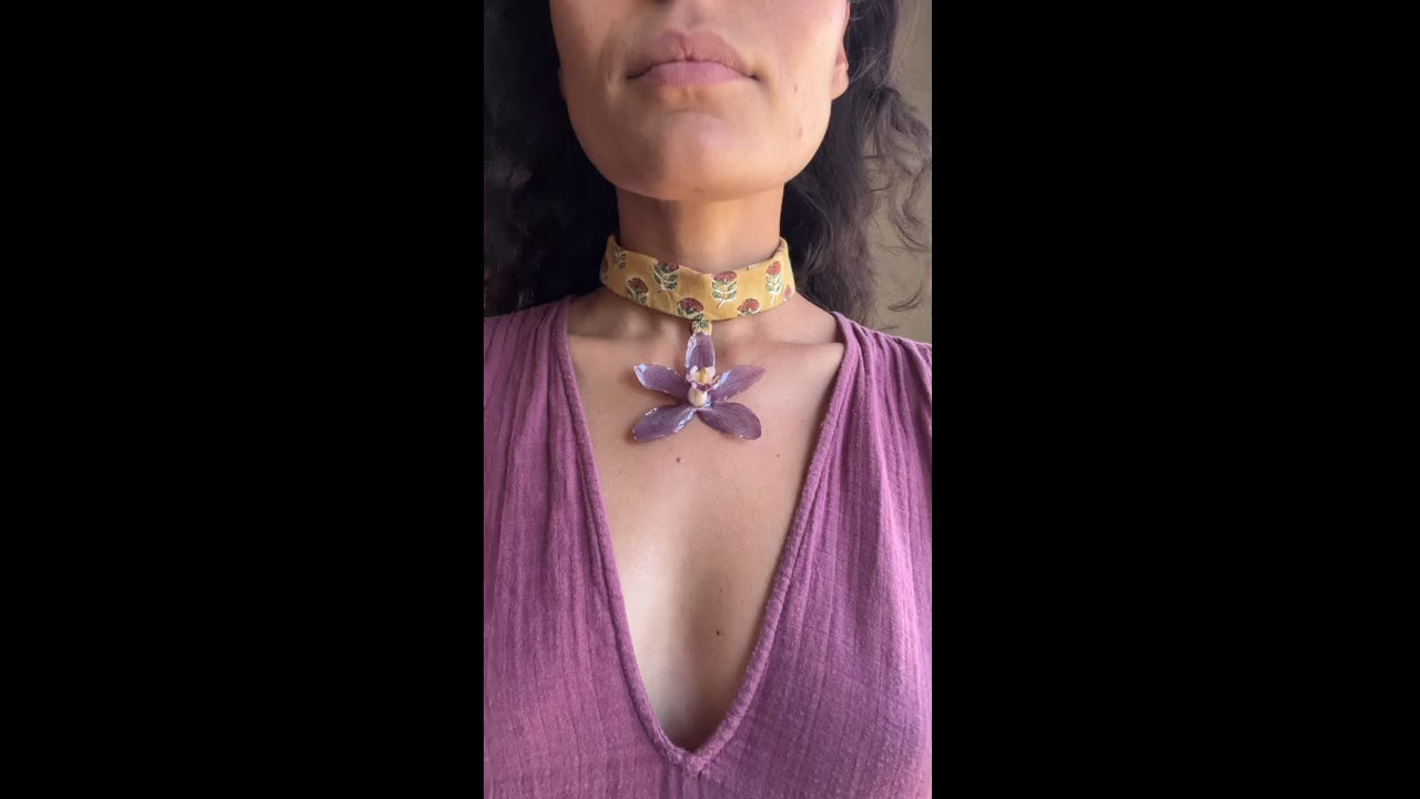 Purple orchid on mustard choker.